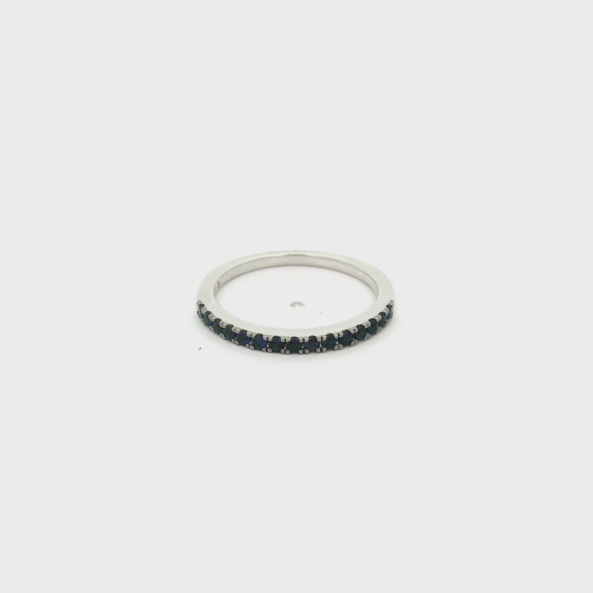 A White Gold Eternity Band with natural Dark Blue Sapphires half way around at Forever Rox Fine Jewelry, Lake Tahoes Best Jewelry Store