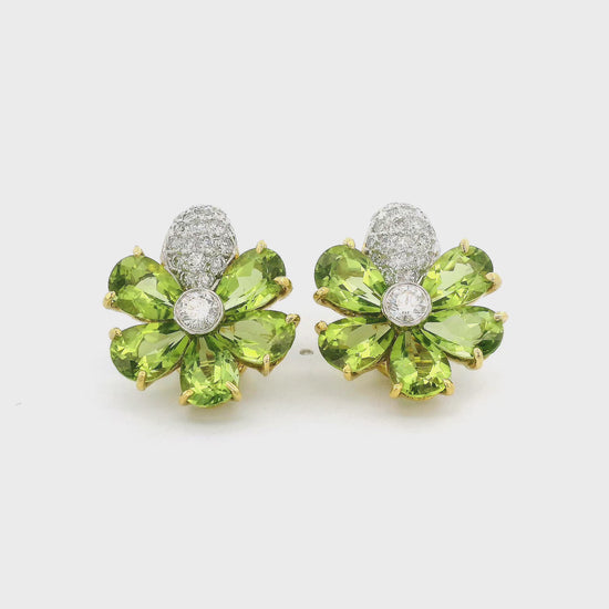 A Pair of Yellow Gold Earrings with a bezel set round cut natural Diamond in the center with 5 natural pear cut peridots surrounding and pavé set natural diamonds at Forever Rox Fine Jewelry, Lake Tahoes Best Jewelry Store