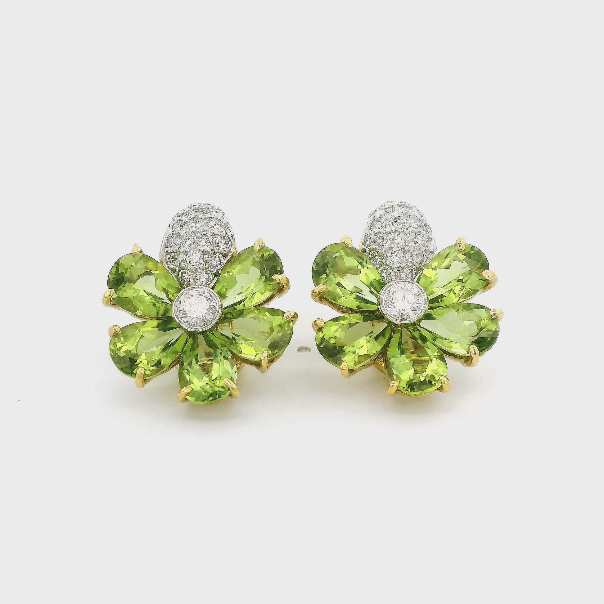 A Pair of Yellow Gold Earrings with a bezel set round cut natural Diamond in the center with 5 natural pear cut peridots surrounding and pavé set natural diamonds at Forever Rox Fine Jewelry, Lake Tahoes Best Jewelry Store