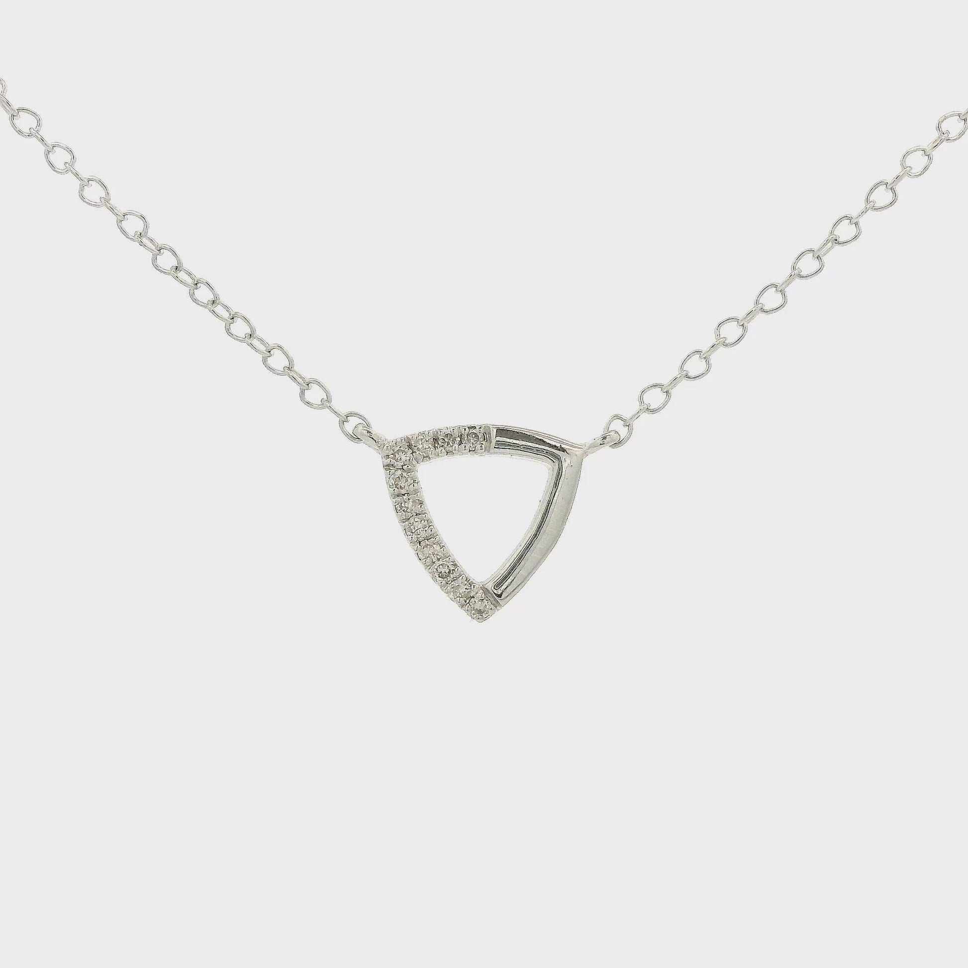 A White Gold Trianlge Shaped Pendant with Diamonds set in half of the pendant with a chain attached at Forever Rox Fine Jewelry, Lake Tahoes Best Jewelry Store
