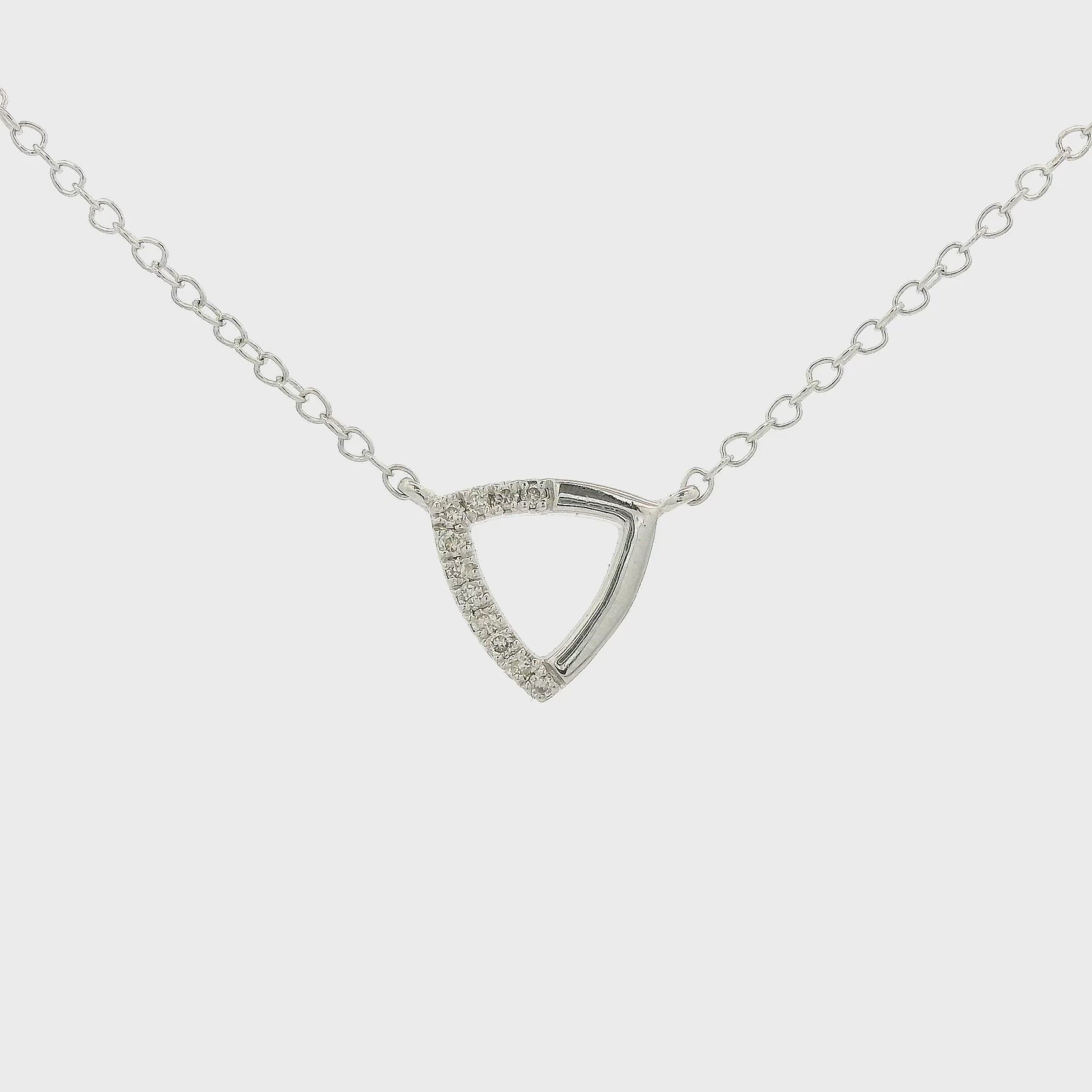 A White Gold Trianlge Shaped Pendant with Diamonds set in half of the pendant with a chain attached at Forever Rox Fine Jewelry, Lake Tahoes Best Jewelry Store
