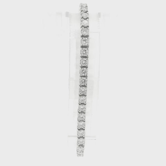 A single white gold diamond tennis bracelet displayed vertically on a clear stand against a plain white background at Forever Rox Fine Jewelry, Lake Tahoes Best Jewelry Store