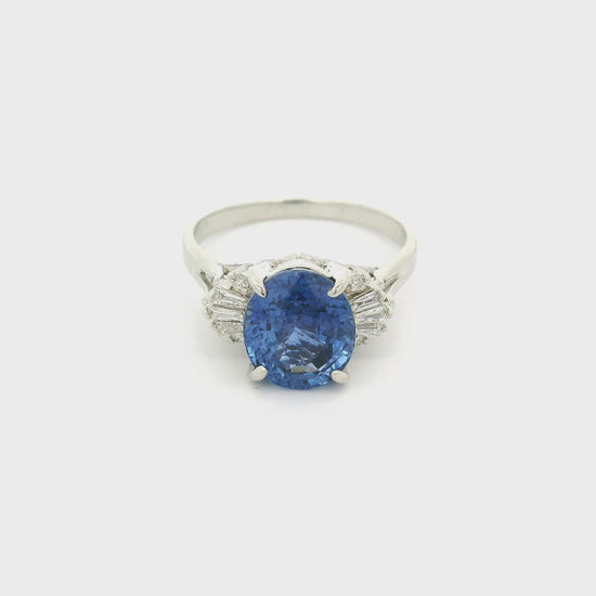 A Platinum Ring with a prong set oval cut natural Ceylon Sapphire in the center with baguette & Round Cut Diamonds at Forever Rox Fine Jewelry, Lake Tahoes Best Jewelry Store