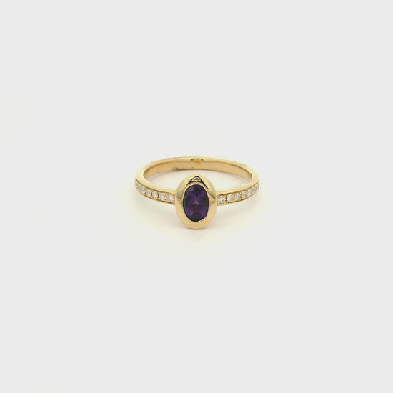 A Yellow Gold Ring with a bezel set oval cut natural Amethyst in the center with diamonds down the shank at Forever Rox Fine Jewelry, Lake Tahoes Best Jewelry Store