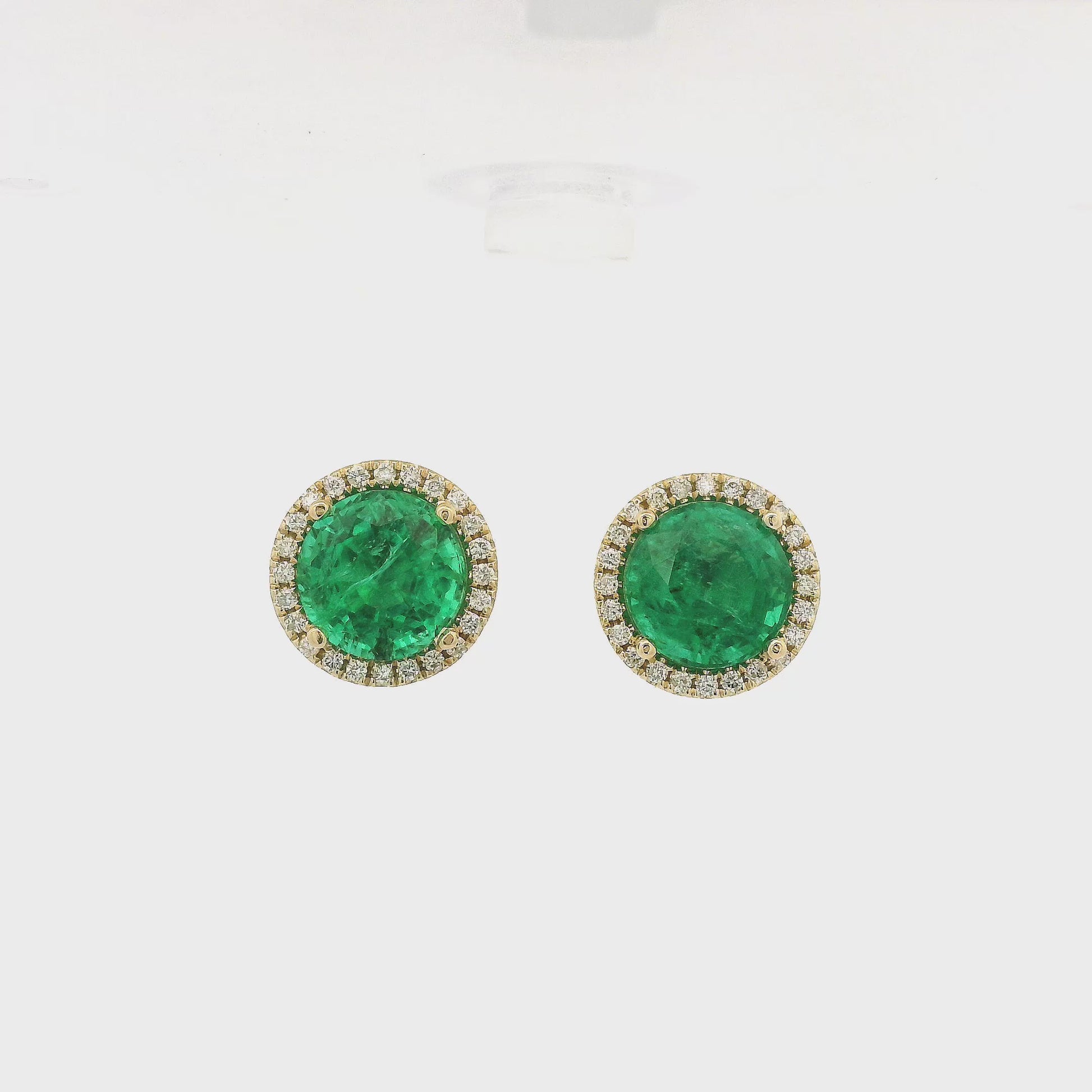 A Pair of Yellow Gold Studs with prong set round cut Emeralds in the center with a diamond halo at Forever Rox Fine Jewelry, Lake Tahoes Best Jewelry Store