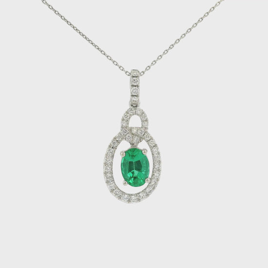 A White Gold Pendant with a prong set oval cut Emerald in the center with a interlinked design pendant with diamonds at Forever Rox Fine Jewelry, Lake Tahoes Best Jewelry Store