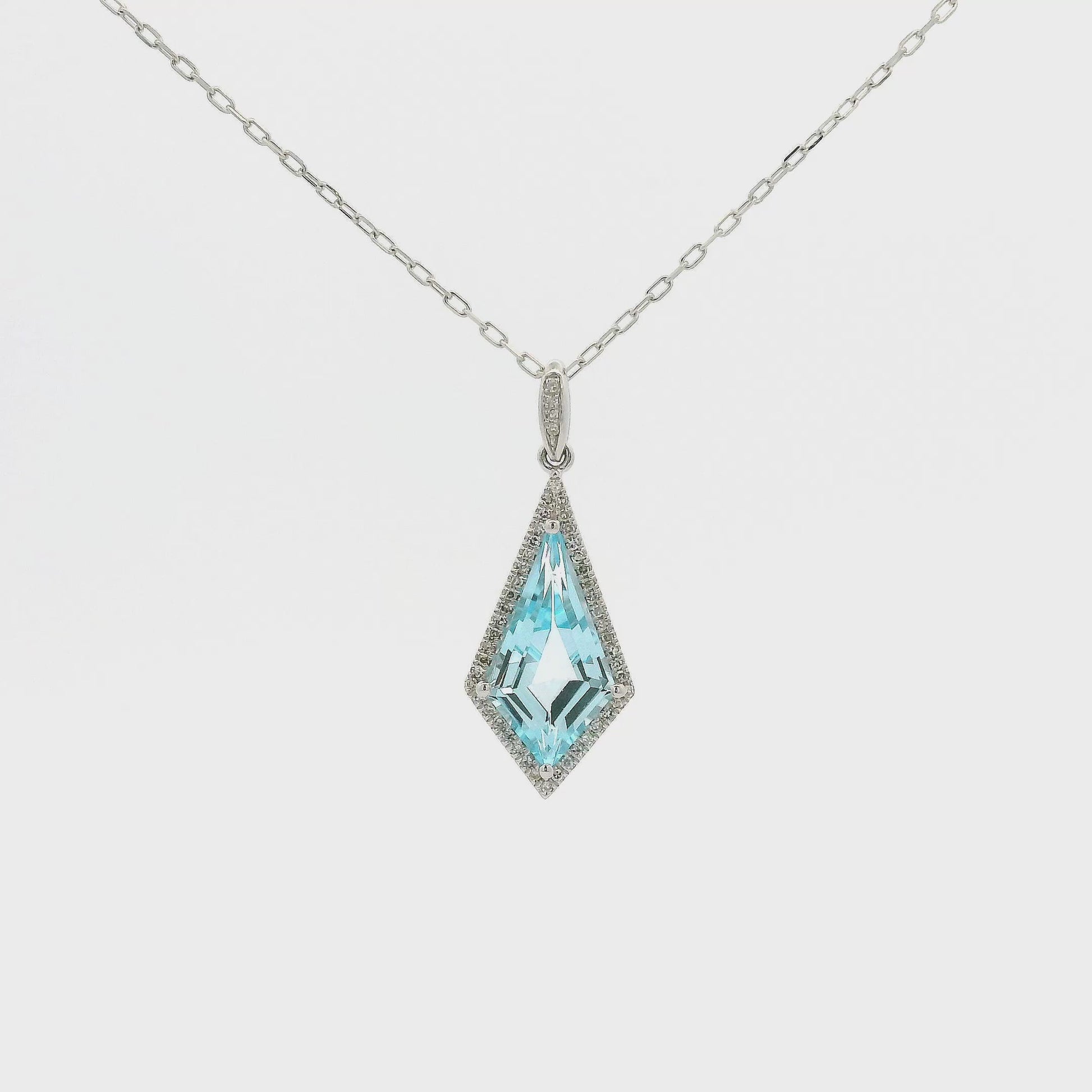 A White Gold Pendant with a prong set kite cut natural Blue Topaz in the center with a halo of Natural Diamonds at Forever Rox Fine Jewelry, Lake Tahoes Best Jewelry Store