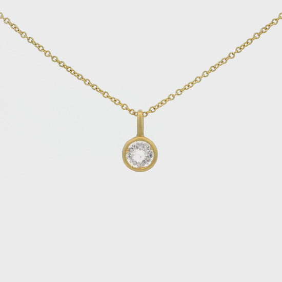 A Yellow Gold Pendant with a solitaire bezel set round cut Morganite in the center at Forever Rox Fine Jewelry, Lake Tahoes Best Jewelry Store
