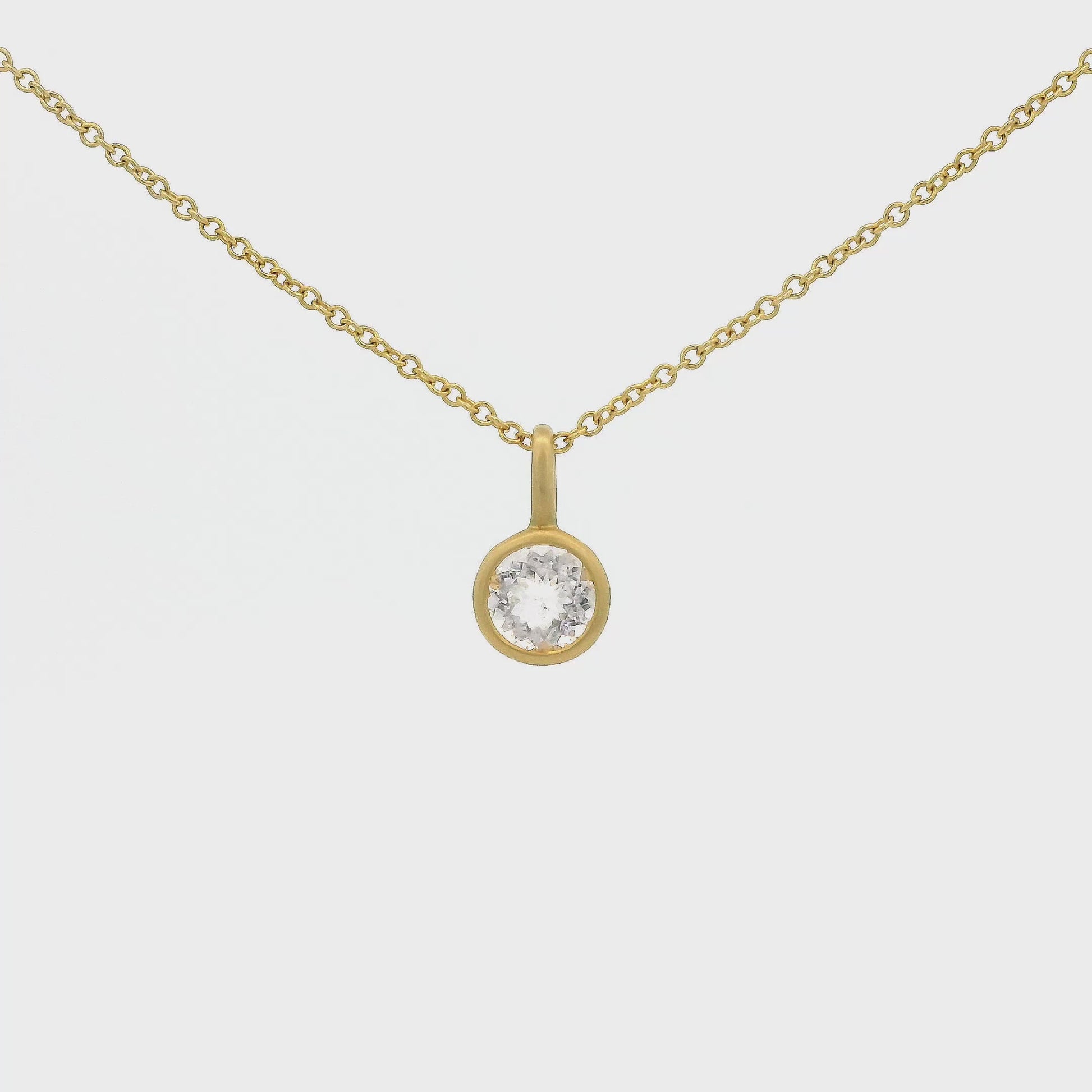 A Yellow Gold Pendant with a solitaire bezel set round cut Morganite in the center at Forever Rox Fine Jewelry, Lake Tahoes Best Jewelry Store