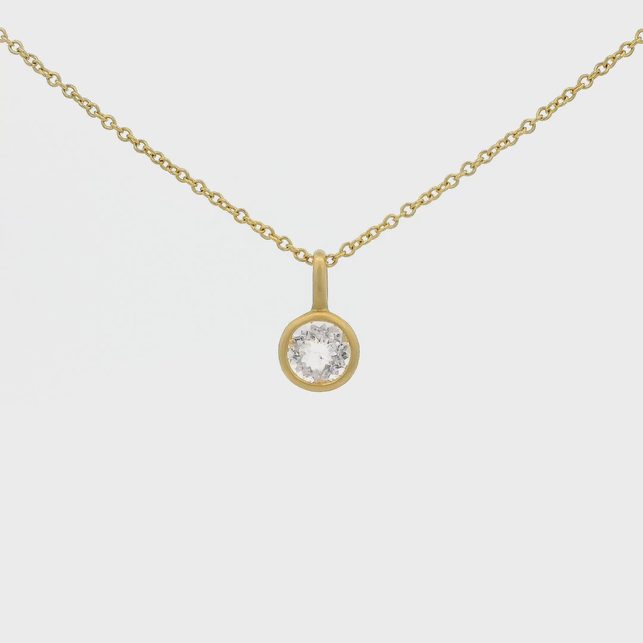 A Yellow Gold Pendant with a solitaire bezel set round cut Morganite in the center at Forever Rox Fine Jewelry, Lake Tahoes Best Jewelry Store