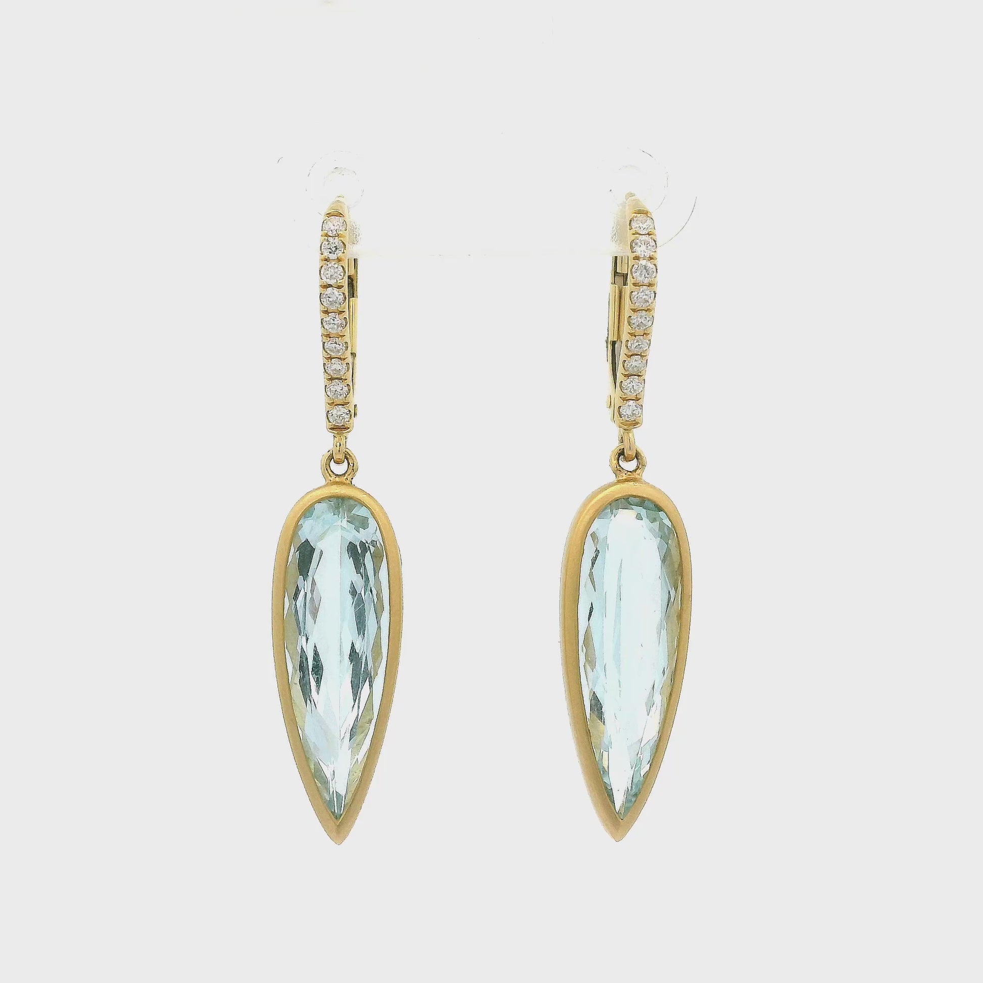A Pair of Yellow Gold Dangle Earrings with bezel set elongated pear cut Aquamarines in the center with diamonds set in the hooks - Lake Tahoe's best Jewelry Store, Forever Rox Fine Jewelry