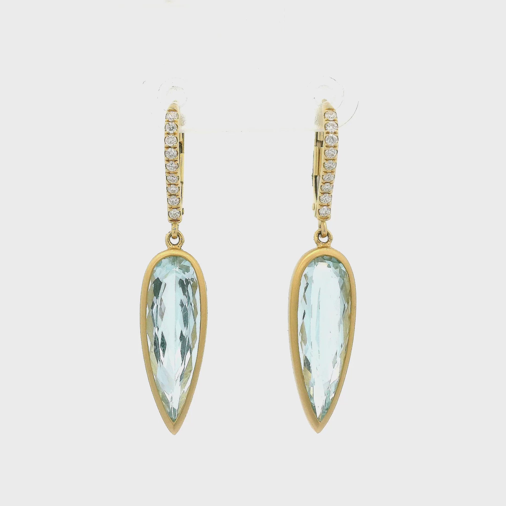 A Pair of Yellow Gold Dangle Earrings with bezel set elongated pear cut Aquamarines in the center with diamonds set in the hooks - Lake Tahoe's best Jewelry Store, Forever Rox Fine Jewelry