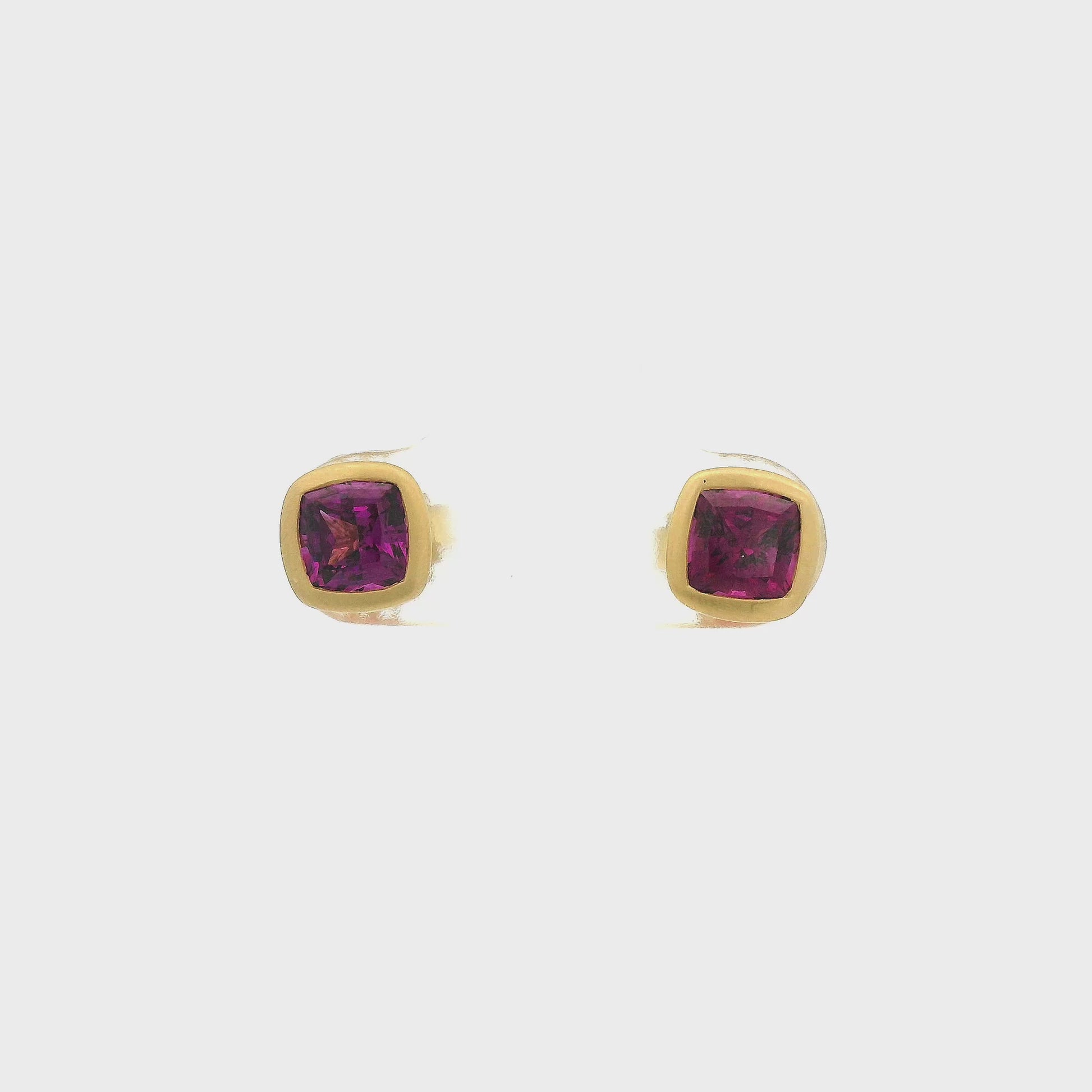 A Pair of Yellow Gold Studs Earrings with bezel set cushion cut natural Purple Garnets in the center at Forever Rox Fine Jewelry, Lake Tahoes Best Jewelry Store