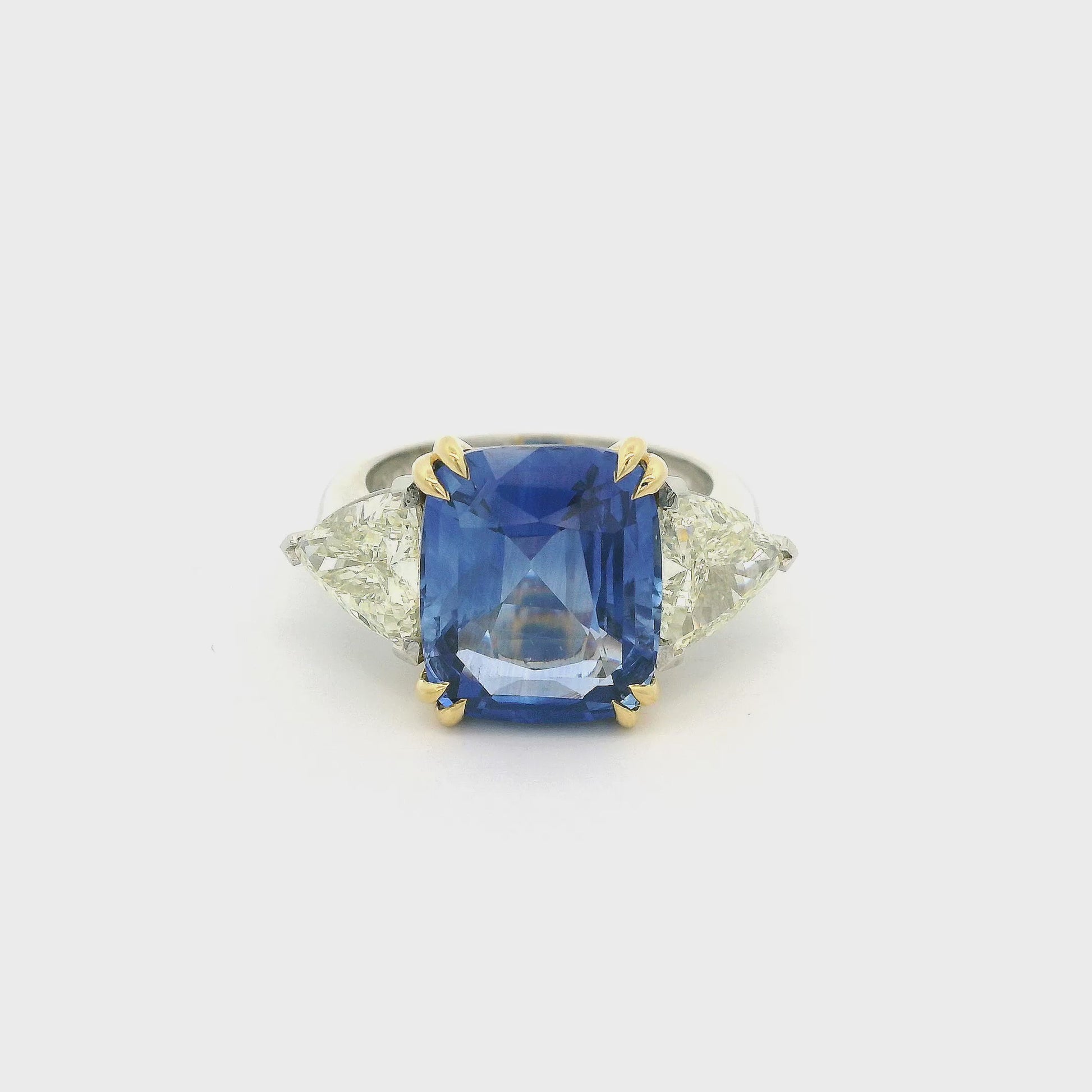 Ring With GIA Certified Cushion Cut Sapphire and Two Trillion Cut Diamonds in Yellow Gold and Platinum at Forever Rox Fine Jewelry