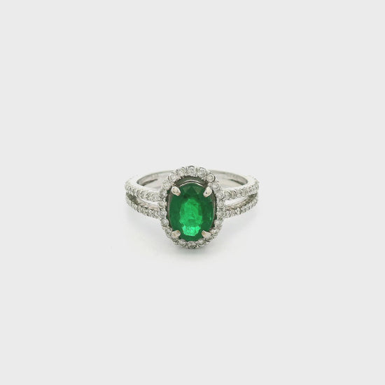 A White Gold Ring with a prong set oval cut natural Emerald in the center with a diamond halo & diamonds down the split shank at Forever Rox Fine Jewelry, Lake Tahoes Best Jewelry Store