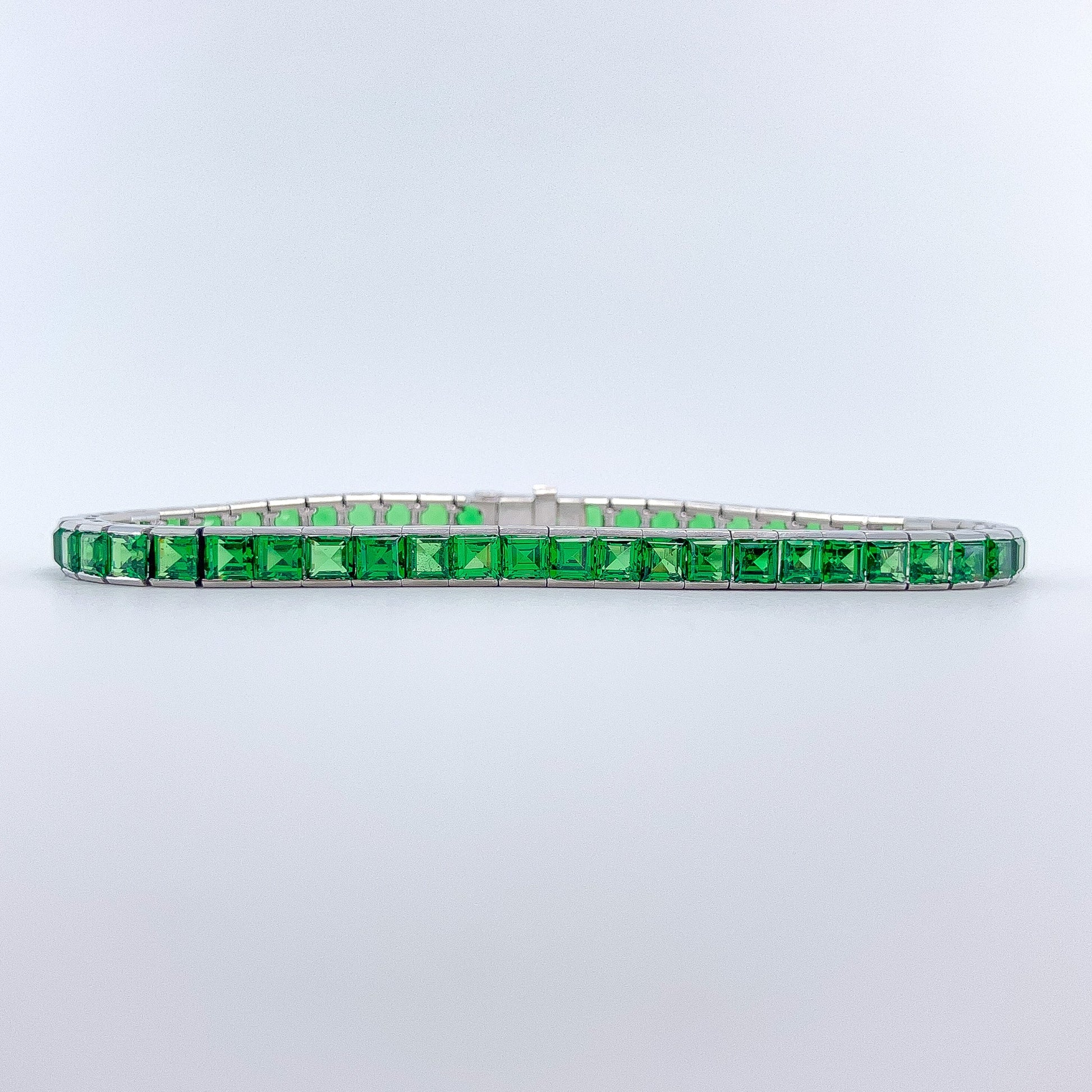 A Platinum Bracelet with square step cut natural Tsavorite Garnets at Forever Rox Fine Jewelry, Lake Tahoes Best Jewelry Store